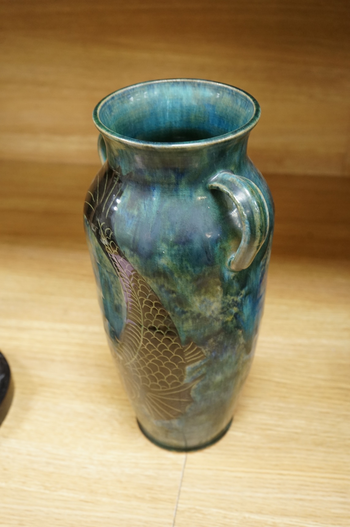 Jane Bridger, a fish designed, green glazed studio pottery two handled vase. 34cm high.